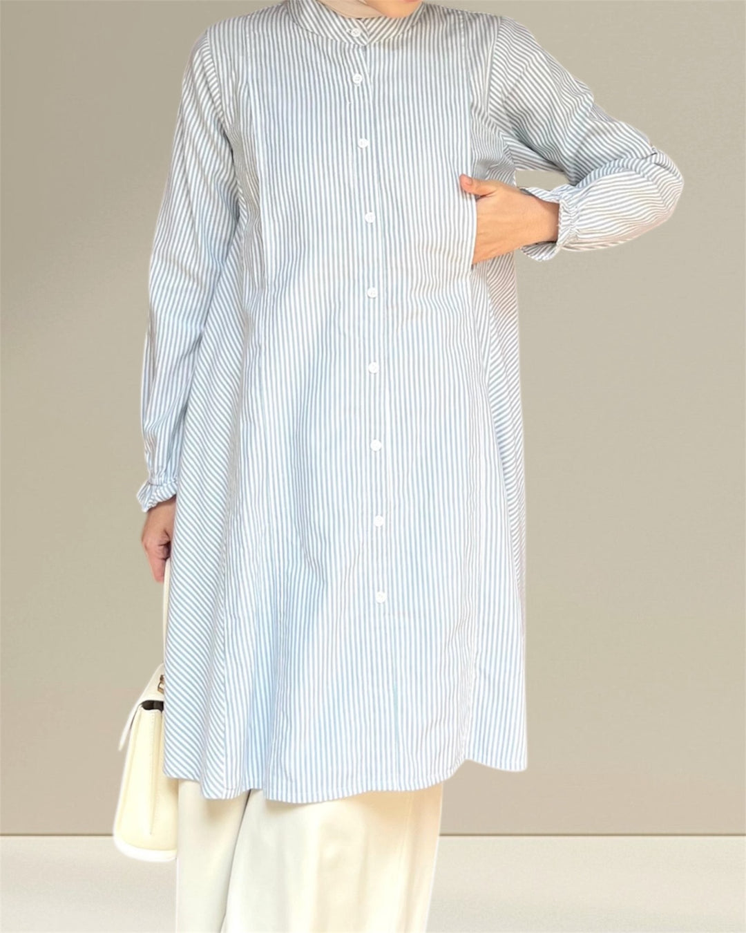 Aliya Nursing Top in white and green stripes, designed for nursing moms with easy breastfeeding access for effortless and discreet feeding.